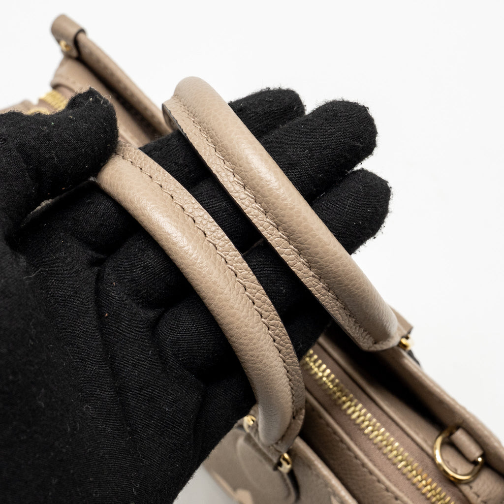 louis-vuitton-onthego-east-west-monogram-empreinte-leather-dove-cream-ghw-copy