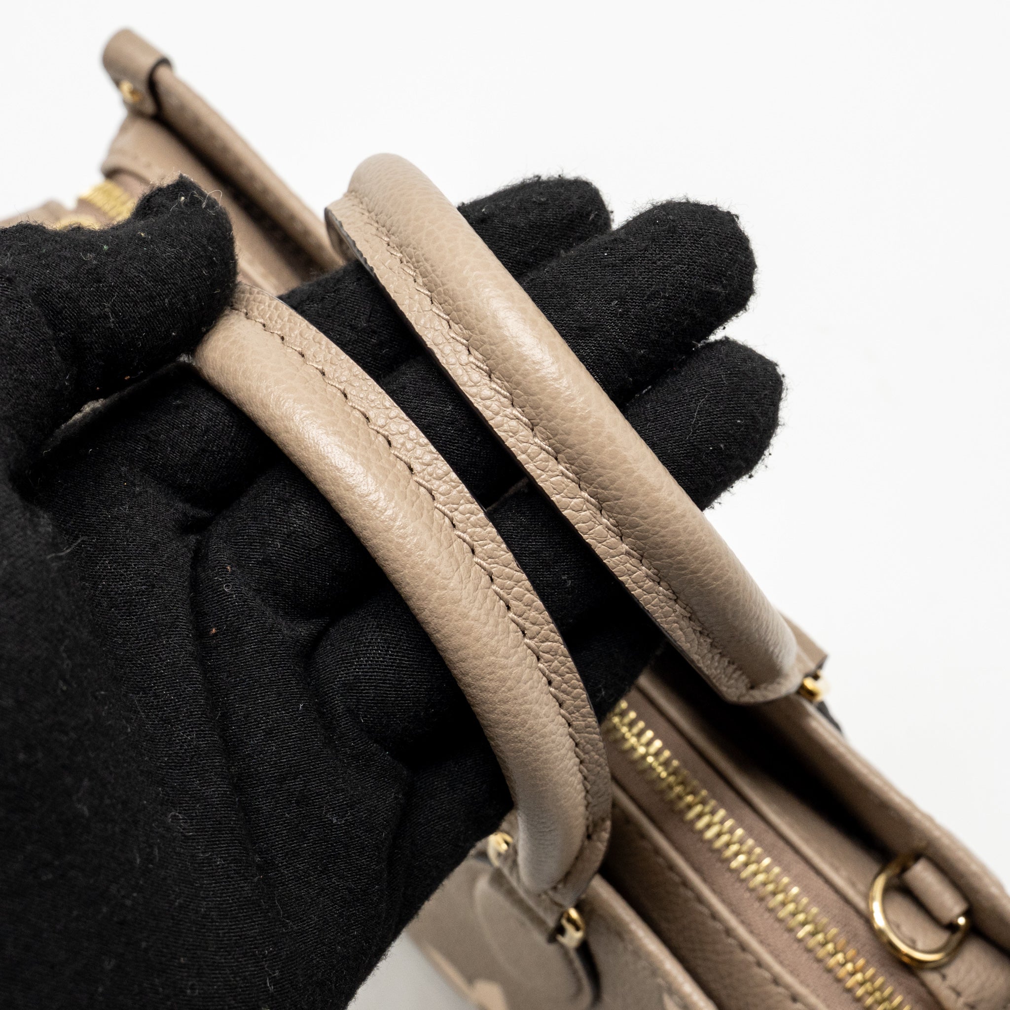 louis-vuitton-onthego-east-west-monogram-empreinte-leather-dove-cream-ghw-copy