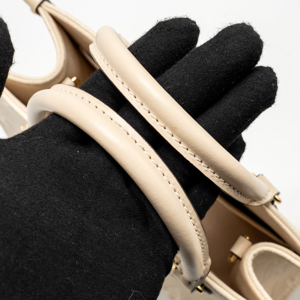 louis-vuitton-onthego-pm-monogram-empreinte-leather-creme-ghw