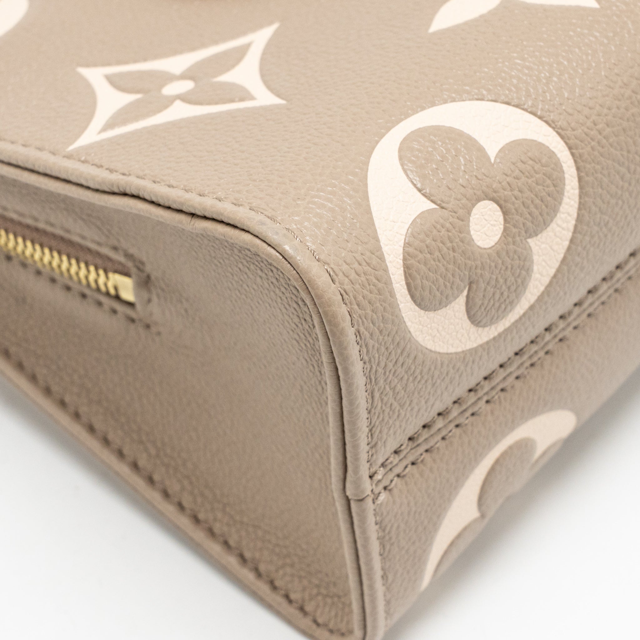 louis-vuitton-onthego-east-west-monogram-empreinte-leather-dove-cream-ghw-copy