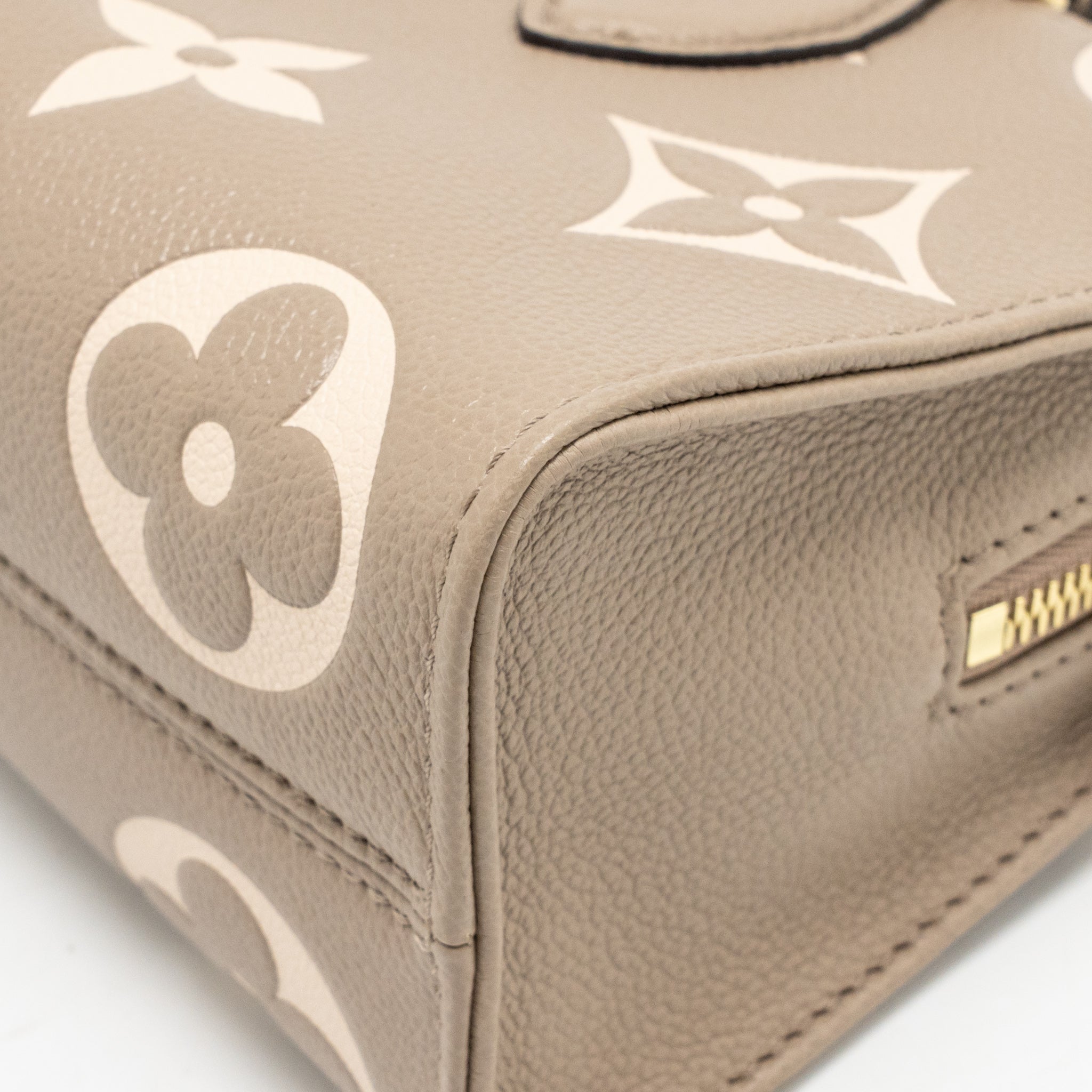 louis-vuitton-onthego-east-west-monogram-empreinte-leather-dove-cream-ghw-copy