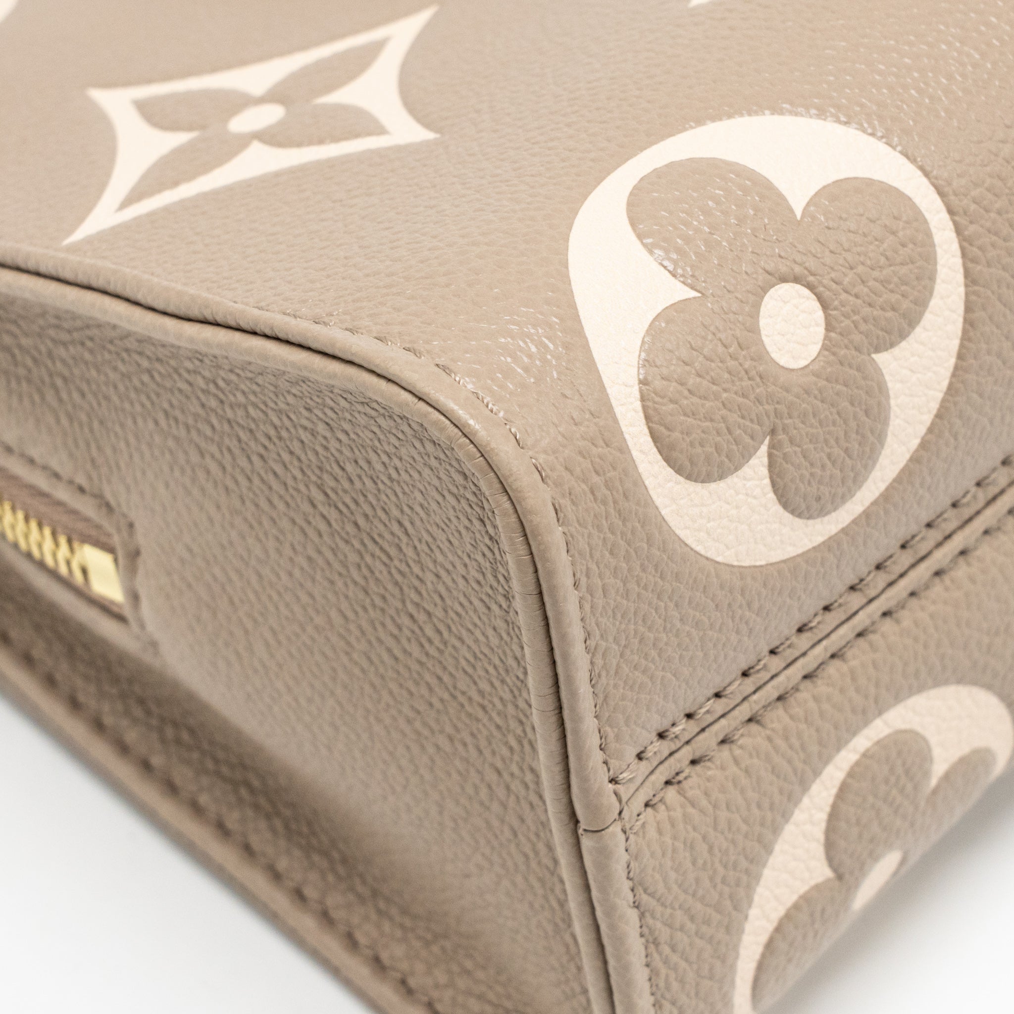 louis-vuitton-onthego-east-west-monogram-empreinte-leather-dove-cream-ghw-copy