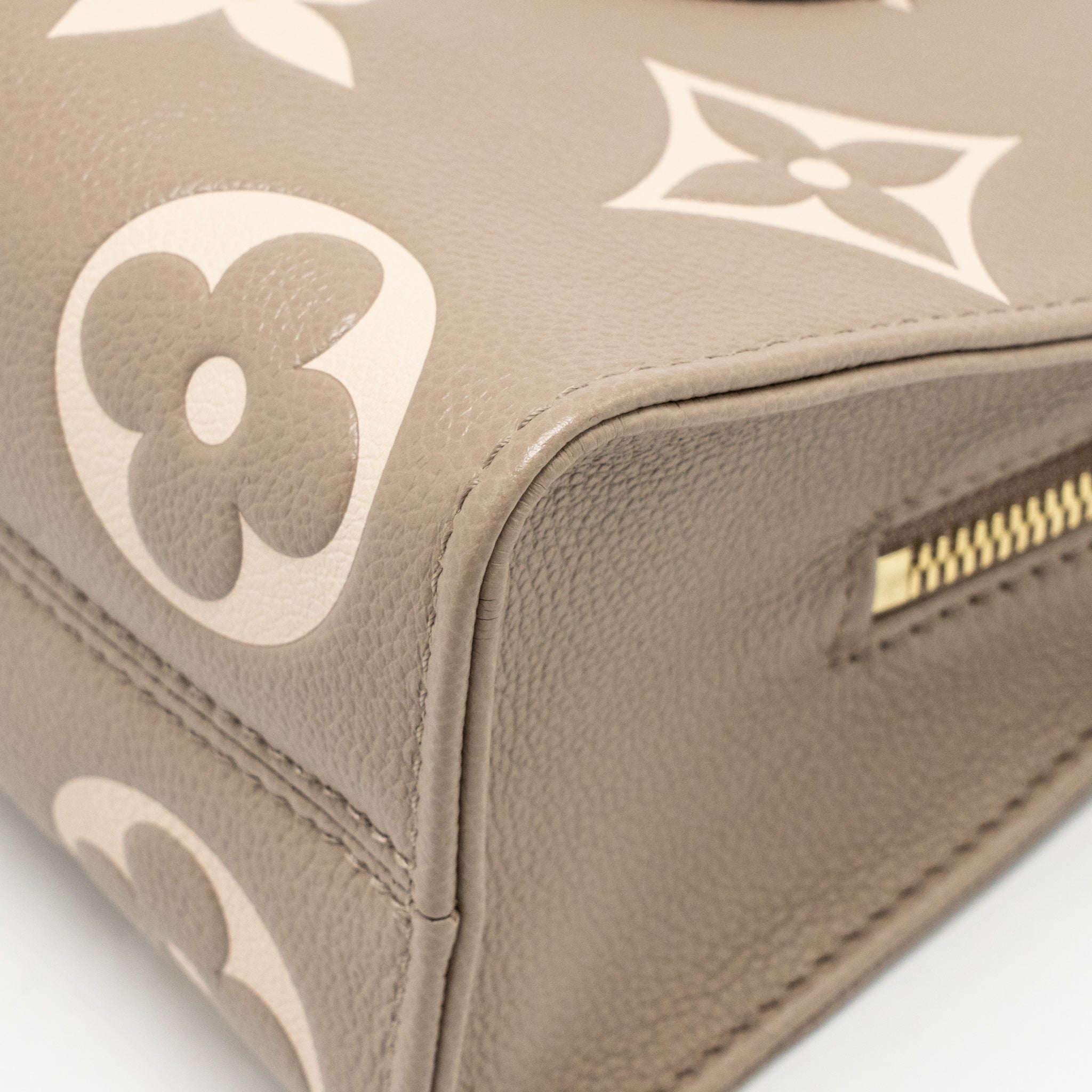 louis-vuitton-onthego-east-west-monogram-empreinte-leather-dove-cream-ghw-copy