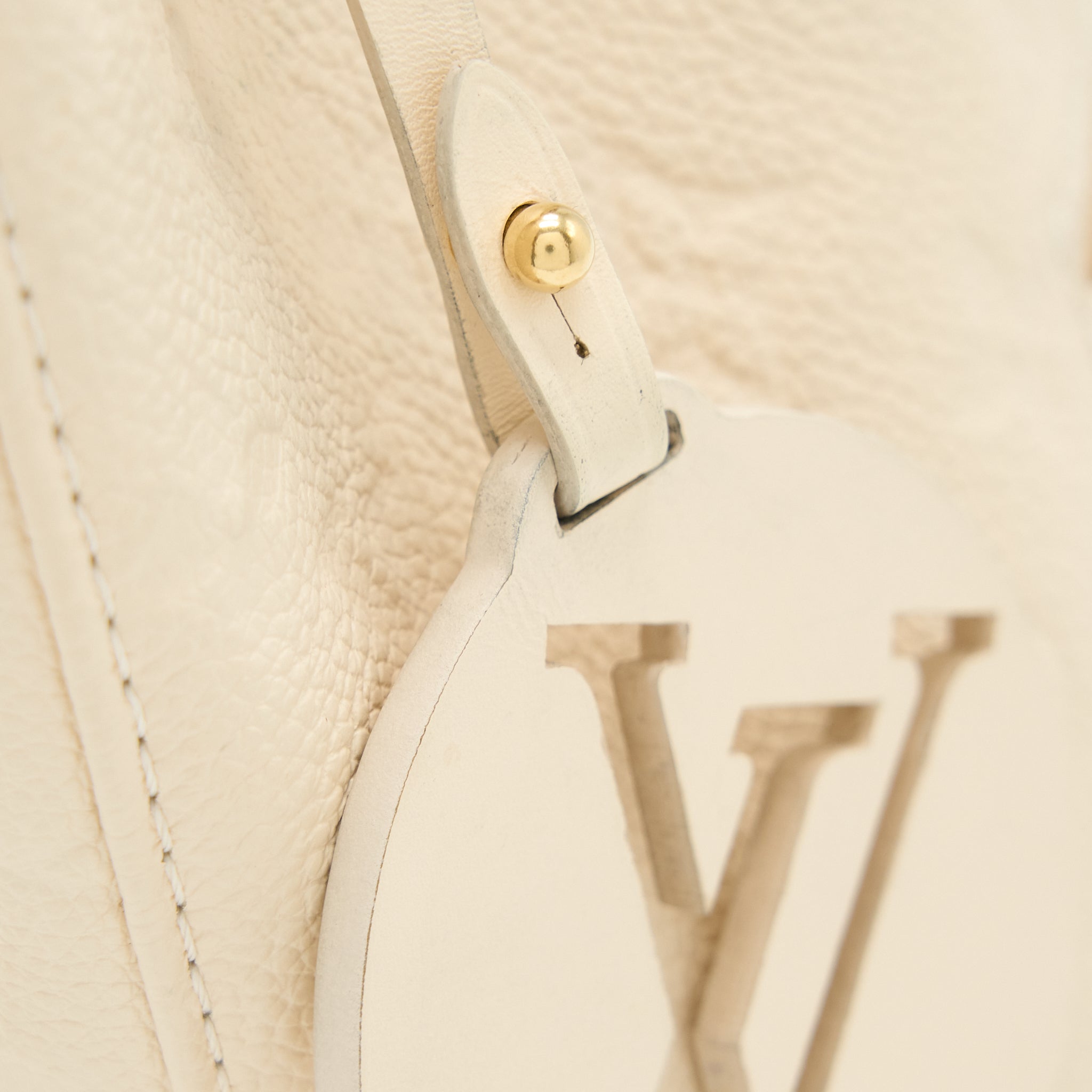 louis-vuitton-montsouris-monogram-empreinte-cream-ghw