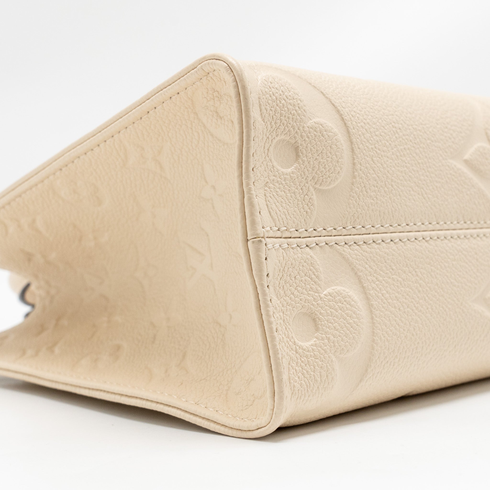 louis-vuitton-onthego-pm-monogram-empreinte-leather-creme-ghw