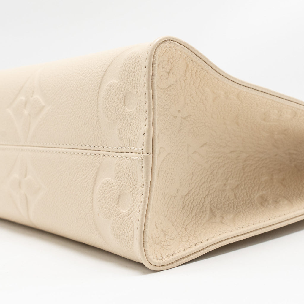 louis-vuitton-onthego-pm-monogram-empreinte-leather-creme-ghw