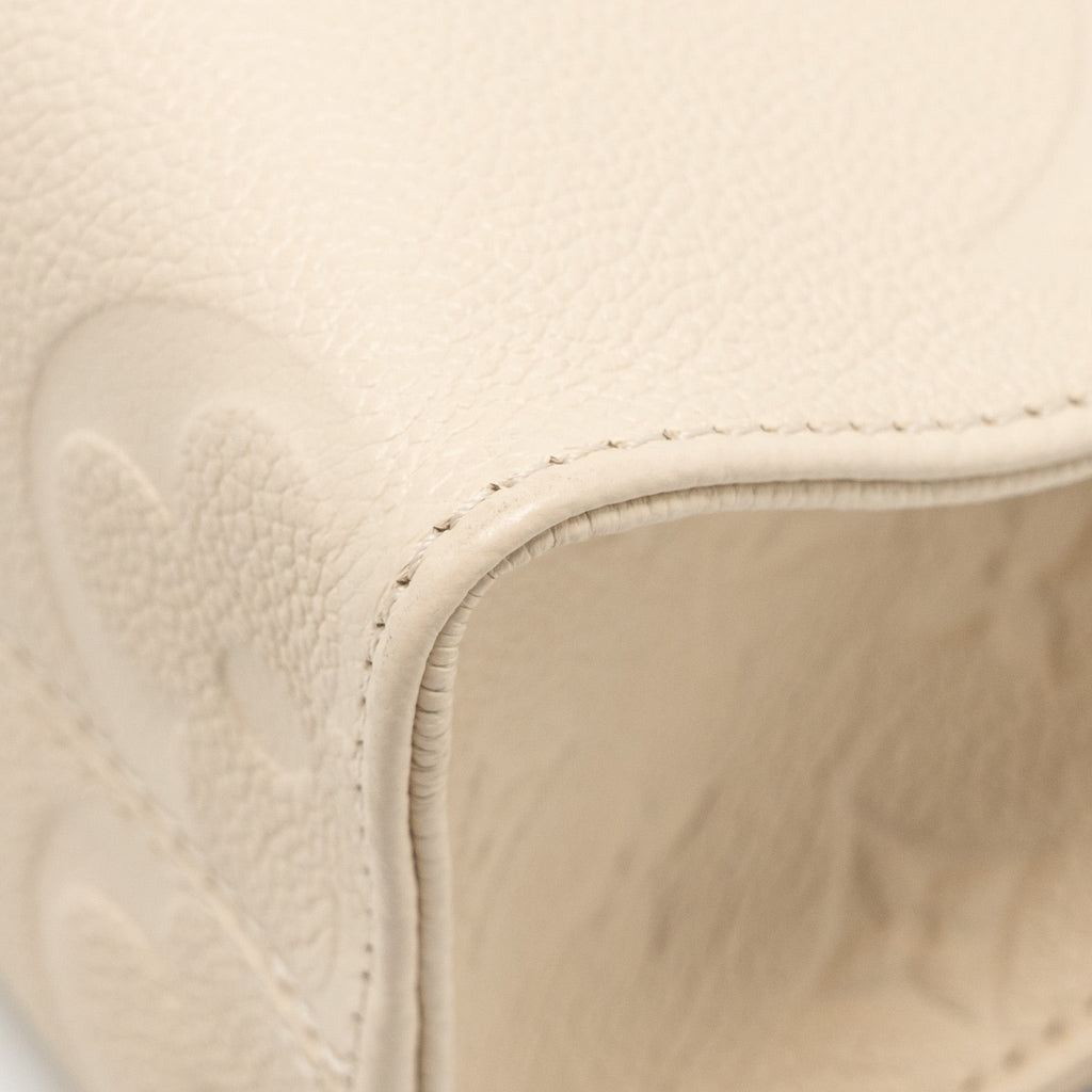 louis-vuitton-onthego-pm-monogram-empreinte-leather-creme-ghw