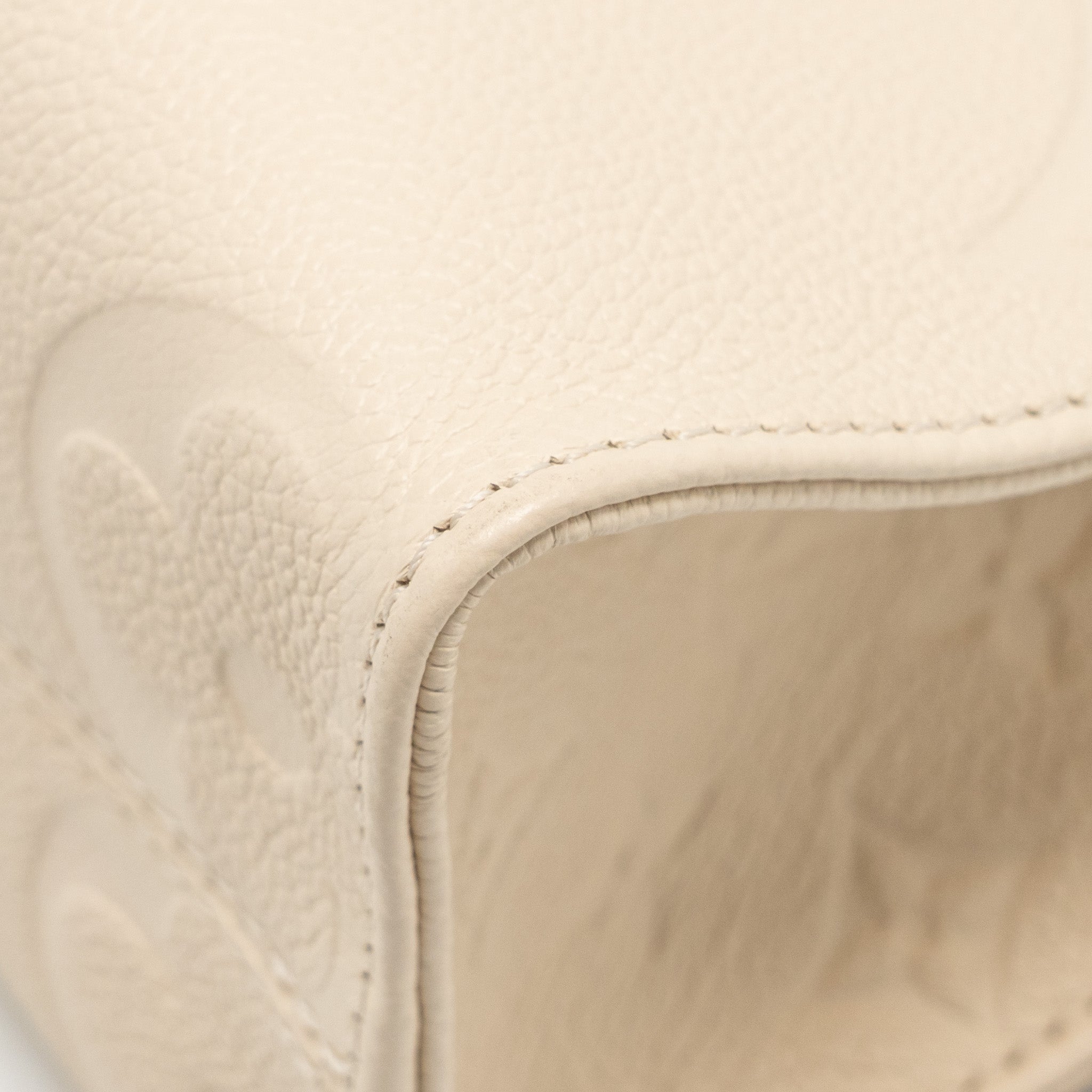 louis-vuitton-onthego-pm-monogram-empreinte-leather-creme-ghw
