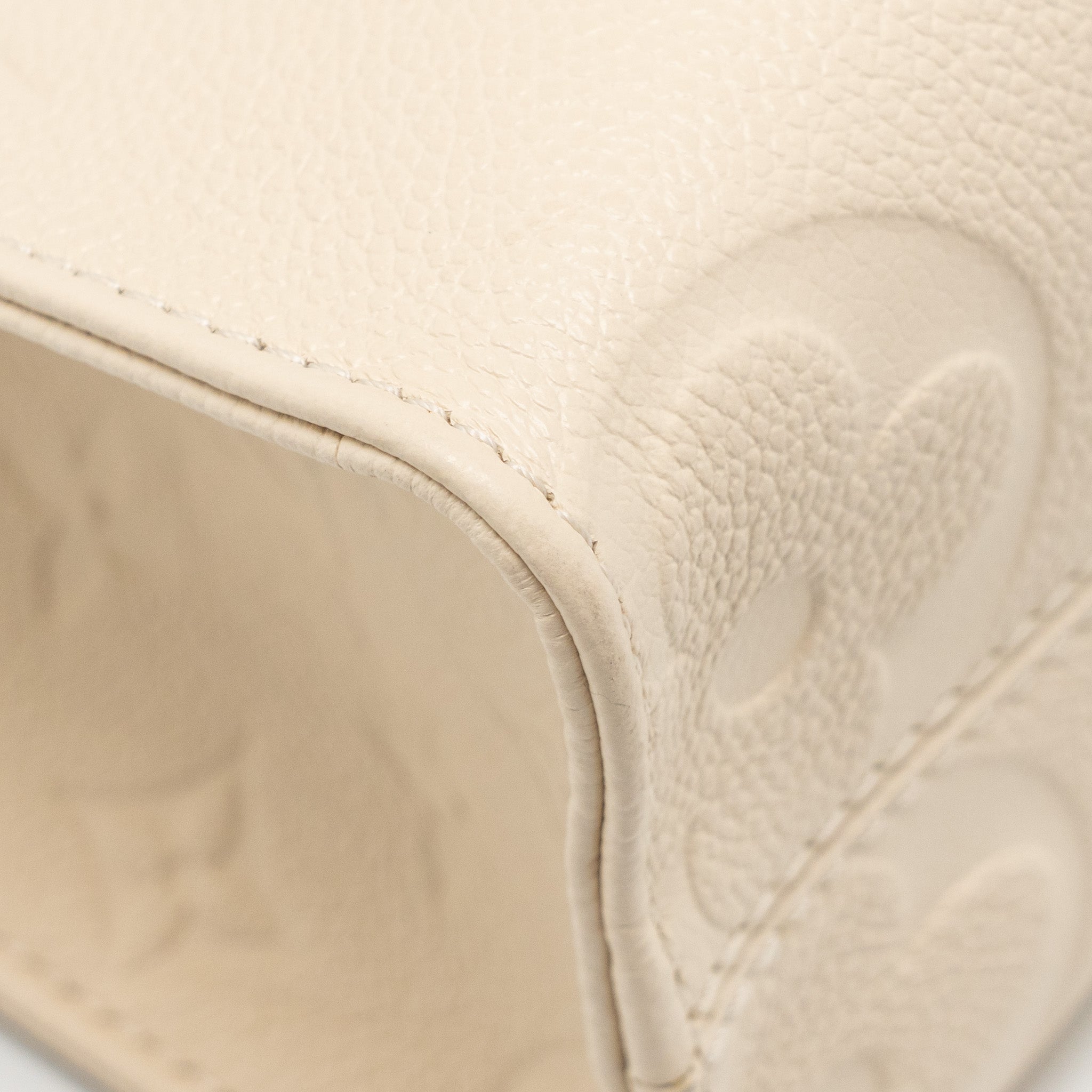 louis-vuitton-onthego-pm-monogram-empreinte-leather-creme-ghw