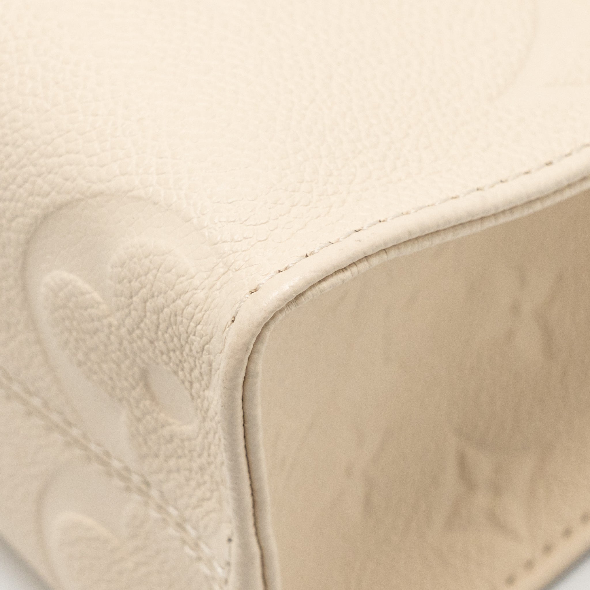 louis-vuitton-onthego-pm-monogram-empreinte-leather-creme-ghw