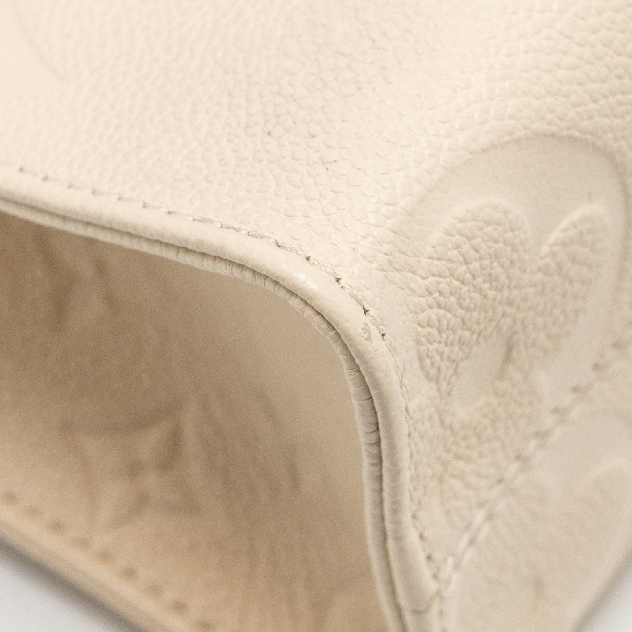 louis-vuitton-onthego-pm-monogram-empreinte-leather-creme-ghw